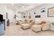 Bright living room with comfortable seating, tile floors, and an open floor plan at 13486 Nobilio St, Venice, FL 34293