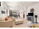 Bright, neutral living room with comfortable seating, tile floors, and an open floor plan at 13486 Nobilio St, Venice, FL 34293