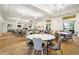 The meeting room features large tables and chairs, neutral decor, and outdoor access at 13486 Nobilio St, Venice, FL 34293
