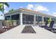Inviting outdoor firepit area with comfortable Adirondack chairs and views of the screened-in porch at 13486 Nobilio St, Venice, FL 34293