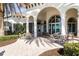Inviting outdoor seating area with tables and chairs under the resort center's shade at 13486 Nobilio St, Venice, FL 34293