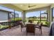 Screened outdoor patio featuring a ceiling fan and view of the water at 13486 Nobilio St, Venice, FL 34293