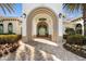 Beautifully landscaped entrance to the Villagewalk Resort Center with arched entryway at 13486 Nobilio St, Venice, FL 34293