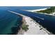 Coastal access point showcasing a channel of water, rocky edge, and white sand beach at 1531 Belfry Dr, Venice, FL 34292