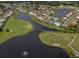 Aerial view showcasing a golf course, waterways, residences, and community landscaping at 1531 Belfry Dr, Venice, FL 34292
