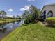 Backyard view of the home featuring a canal with serene water views and lush green landscaping at 1531 Belfry Dr, Venice, FL 34292