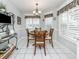 Sunlit dining area with traditional decor, white shutters, and white tile floors at 1531 Belfry Dr, Venice, FL 34292