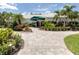 A walkway leads to the Waterford Sports Club with lush landscaping at 1531 Belfry Dr, Venice, FL 34292