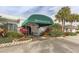 The Waterford Golf Club entrance, showcasing lush landscaping, a covered entrance and well-maintained grounds at 1531 Belfry Dr, Venice, FL 34292