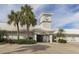 Exterior of the Waterford Sports Club and clock tower surrounded by lush greenery at 1531 Belfry Dr, Venice, FL 34292