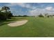 Scenic golf course view featuring lush green fairways and a sand bunker at 1531 Belfry Dr, Venice, FL 34292