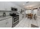 Stainless appliances, white cabinets, granite counters, and breakfast nook featured in the kitchen at 1531 Belfry Dr, Venice, FL 34292
