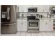 Updated kitchen with stainless steel appliances, granite counters, and white cabinets at 1531 Belfry Dr, Venice, FL 34292