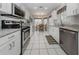 Bright kitchen features stainless appliances, white cabinetry and granite countertops at 1531 Belfry Dr, Venice, FL 34292