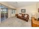 Comfortable living room with a plush sofa, ceiling fan and natural light at 1531 Belfry Dr, Venice, FL 34292