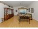 Inviting living room featuring laminate floors, neutral walls, comfortable sofas, and a large wooden entertainment center at 1531 Belfry Dr, Venice, FL 34292