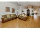Spacious living room featuring laminate floors, comfortable sofas, and neutral wall colors at 1531 Belfry Dr, Venice, FL 34292