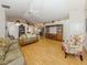 Bright living room with vaulted ceiling, neutral walls, laminate floors, and comfortable seating at 1531 Belfry Dr, Venice, FL 34292