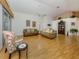 Bright living room features wood floors, neutral walls, high ceilings, and comfortable seating at 1531 Belfry Dr, Venice, FL 34292