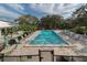 An aerial view of the fenced community pool area and surrounding trees at 1531 Belfry Dr, Venice, FL 34292