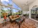 Inviting sunroom featuring tile flooring, a comfortable seating area, and scenic views at 1531 Belfry Dr, Venice, FL 34292