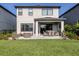Backyard featuring a paved patio with dining and seating areas, plus a lawn at 15364 Isla Palma Ln, Nokomis, FL 34275