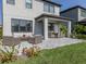 A covered patio with furniture and a grassy backyard at 15364 Isla Palma Ln, Nokomis, FL 34275