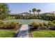 Community basketball court surrounded by lush landscaping and secure fencing at 15364 Isla Palma Ln, Nokomis, FL 34275