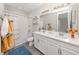 Charming bathroom with a double vanity, tub and shower combo, and colorful decor at 15364 Isla Palma Ln, Nokomis, FL 34275