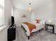 Comfortable bedroom featuring carpet flooring, a woven pendant light, and warm decor at 15364 Isla Palma Ln, Nokomis, FL 34275