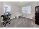Neutral bedroom with a white crib, keyboard, and grey carpet at 15364 Isla Palma Ln, Nokomis, FL 34275