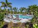 Gorgeous community pool with lounge chairs and lush landscaping, perfect for relaxation at 15364 Isla Palma Ln, Nokomis, FL 34275