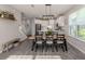 Open dining space showcasing a wooden table, views into the kitchen, and natural light from the window at 15364 Isla Palma Ln, Nokomis, FL 34275
