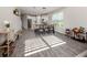Inviting dining area with modern light fixture, wood table, and views into the kitchen and living spaces at 15364 Isla Palma Ln, Nokomis, FL 34275