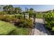 Community dog park entrance with signage, landscaping, and secure fencing at 15364 Isla Palma Ln, Nokomis, FL 34275