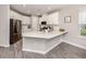 Modern kitchen featuring stainless steel appliances, white cabinetry, and a stylish quartz countertop at 15364 Isla Palma Ln, Nokomis, FL 34275