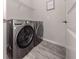 A modern laundry room featuring a gray washer and dryer set at 15364 Isla Palma Ln, Nokomis, FL 34275