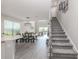 Bright and open living area features a dining table and staircase at 15364 Isla Palma Ln, Nokomis, FL 34275