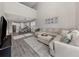 Open-concept living space with tile floors, a large sectional, and a modern kitchen at 15364 Isla Palma Ln, Nokomis, FL 34275