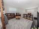 Upstairs living room featuring a brown leather couch, armchair and shelves at 15364 Isla Palma Ln, Nokomis, FL 34275