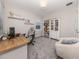 Bright office space with grey carpet, built-in shelves, desk, and chair at 15364 Isla Palma Ln, Nokomis, FL 34275