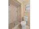 Bathroom featuring a walk in shower, toilet, and window at 1728 S Lakeside Dr # 1720B, Venice, FL 34293