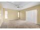 Bright bedroom featuring neutral carpeting and several windows letting in natural light at 1728 S Lakeside Dr # 1720B, Venice, FL 34293