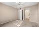 Bedroom featuring a ceiling fan, closet, and doorway to other rooms at 1728 S Lakeside Dr # 1720B, Venice, FL 34293