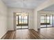 Open dining area with modern lighting fixture, wood-look floors and slider to lanai at 1728 S Lakeside Dr # 1720B, Venice, FL 34293