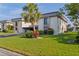 Well-maintained condo building with lush landscaping and covered parking on a sunny day at 1728 S Lakeside Dr # 1720B, Venice, FL 34293
