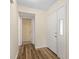 Hallway features wood flooring and doors to other rooms in the home at 1728 S Lakeside Ct # 1720B, Venice, FL 34293