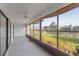 Enclosed sunroom provides tranquil views with neutral finishes and a ceiling fan for added comfort at 1728 S Lakeside Dr # 1720B, Venice, FL 34293