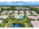 Beautiful aerial view of the community featuring lush landscaping, pool, and serene pond at 1799 Fountain View Cir, Venice, FL 34292
