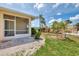 Spacious backyard with lush lawn, well-kept landscaping, and screened in porch perfect for outdoor relaxation at 1799 Fountain View Cir, Venice, FL 34292